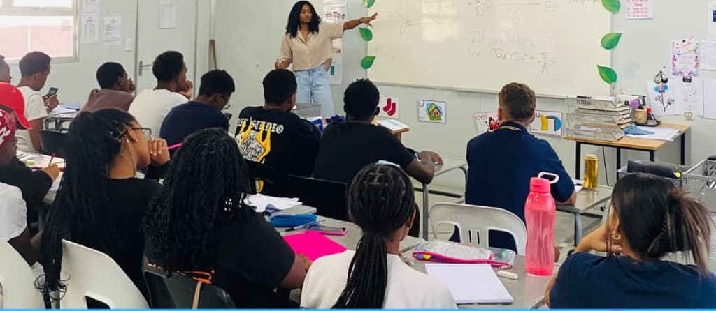 Classroom session with a tutor at the whiteboard and learners at their desks